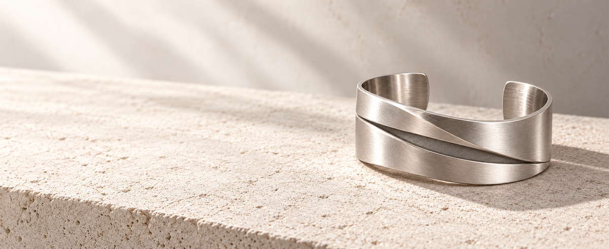 Editorial silver folded cuff on pale limestone